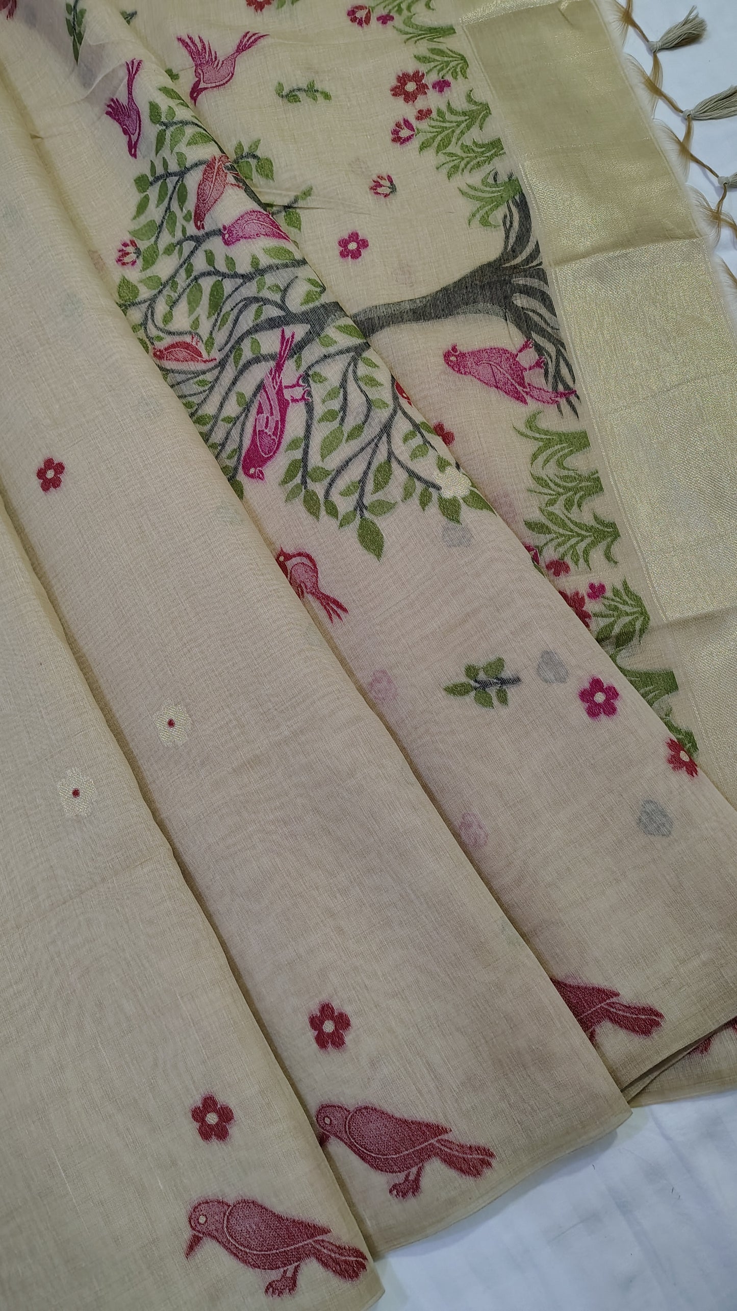 saree with floral and tree design on a beige background