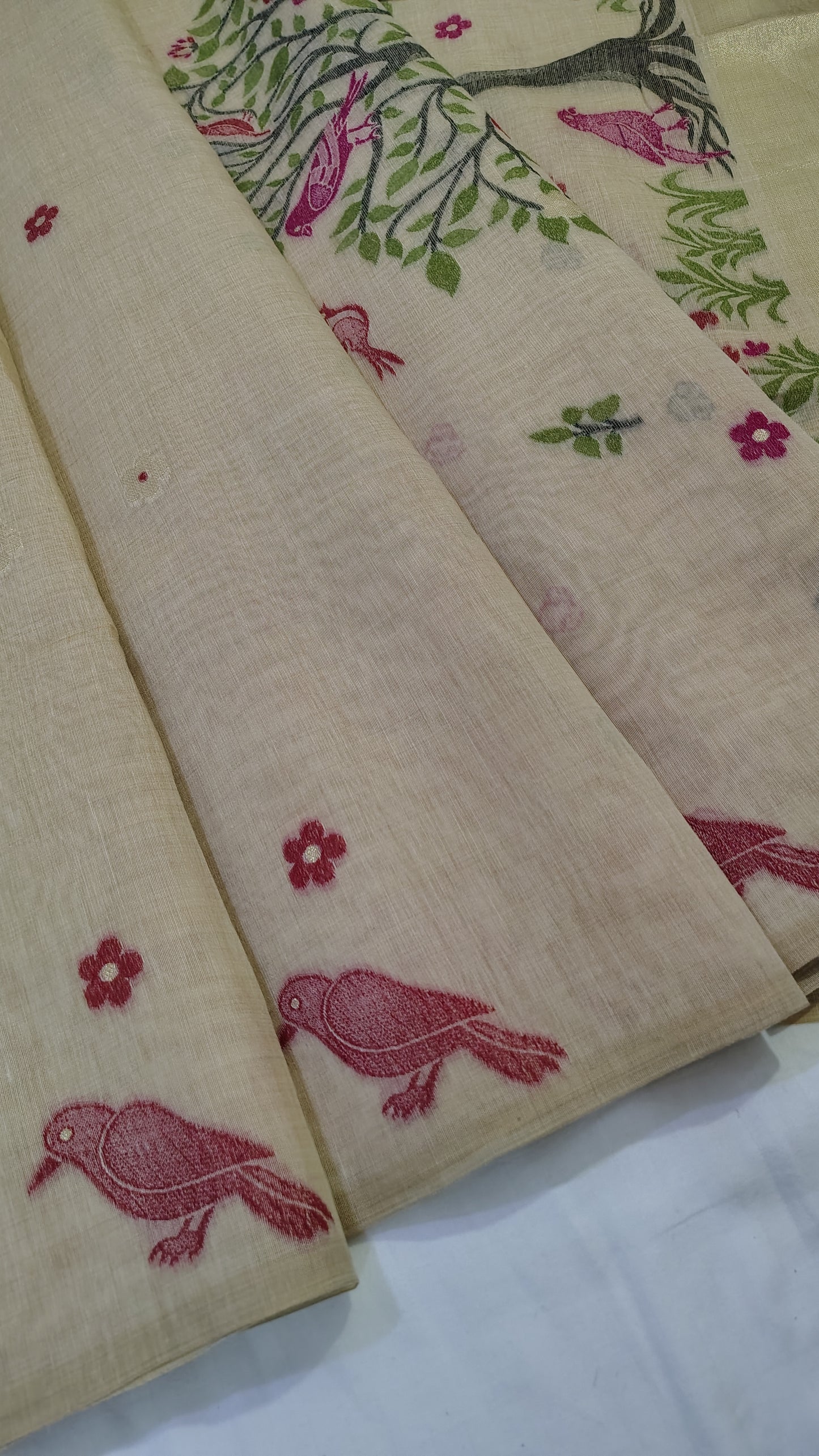 bird and floral patterns on a beige Saree